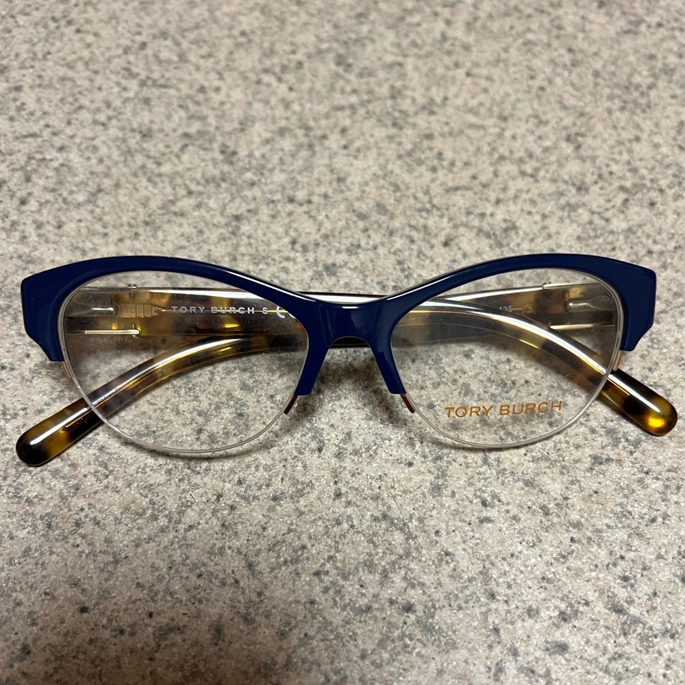 Tory Burch optical glasses on tortoise with navy blue and gold details .